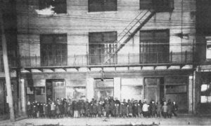 Boys line up outside the Dutton Street Club in 1920.